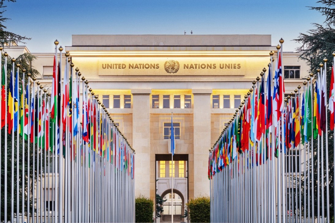 United Nations headquarters building with rows of international flags representing global policy discussions and international negotiations